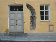 Gothic arch cemented between a door and a window