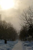 Narrow path under blizzard leading to a distant church